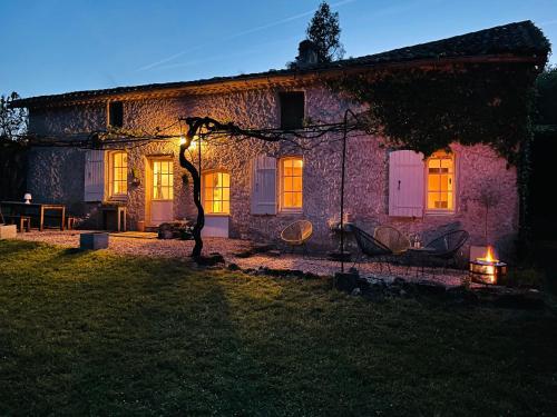 a stone house at night with a light on it at Maison des Vignes in Le Fleix