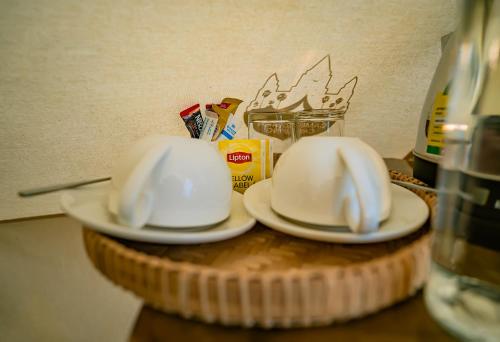two white hats sitting on plates on a table at Green Valley Veal Pouch in Kampot