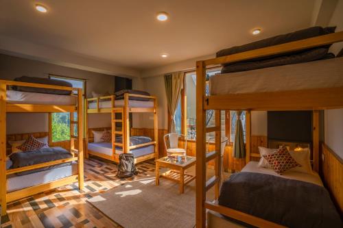 a room with four bunk beds in a house at Zostel Manali, Vashisht in Vashisht