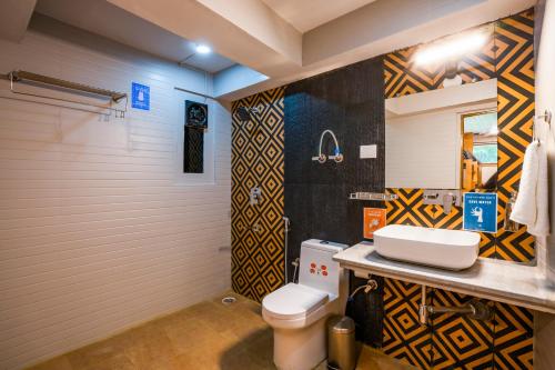 a bathroom with a toilet and a sink at Zostel Manali, Vashisht in Vashisht