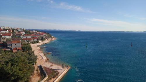 an aerial view of a beach and the ocean at Apartment Vuletic, Ždrelac Pašman in Ždrelac