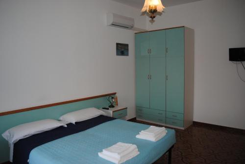 En eller flere senge i et værelse på B&b La Scogliera