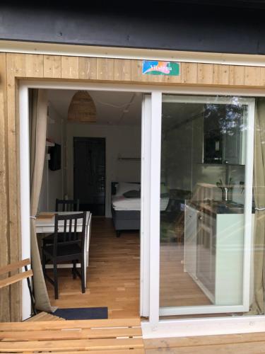 a sliding glass door leading to a room with a bedroom at Kaggeholms strandboende in Ekerö