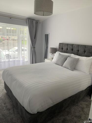 a large white bed in a bedroom with a window at Stonehaven in Kilkenny