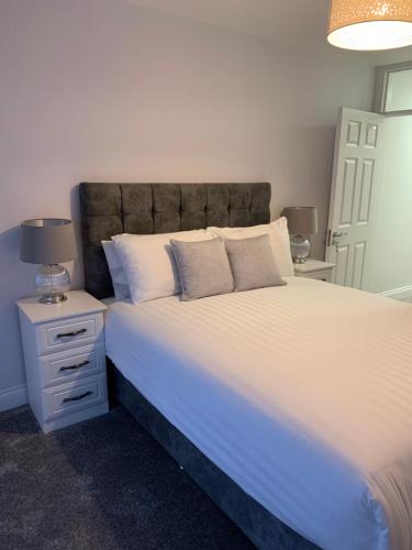 a bedroom with a large bed with white sheets and pillows at Stonehaven in Kilkenny