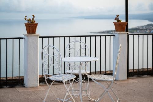 a table and two chairs sitting on a balcony at Hotel Elios Tao in Taormina