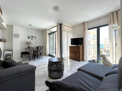 a living room with a couch and a table at Bear Holiday - Apartment Lynn with Seaview in Moraira near the Beach in Moraira