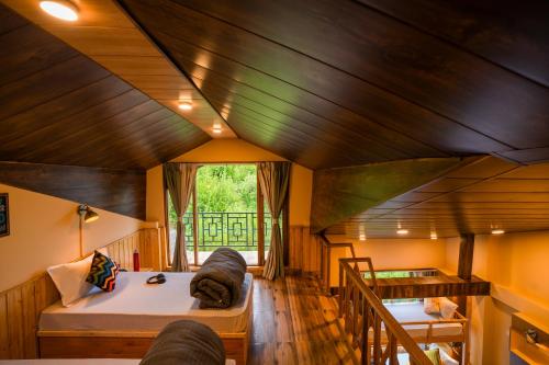 a room with a bed and a couch in a house at Zostel Manali, Vashisht in Vashisht