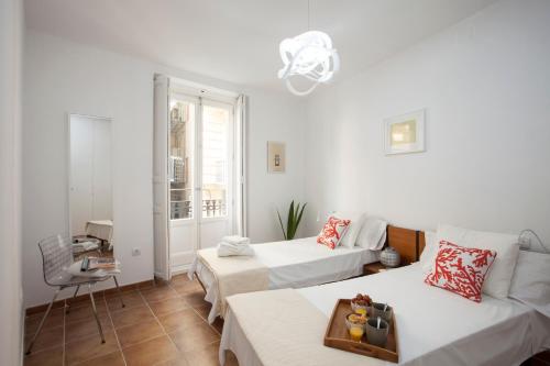 En eller flere senge i et værelse på SingularStays Roteros