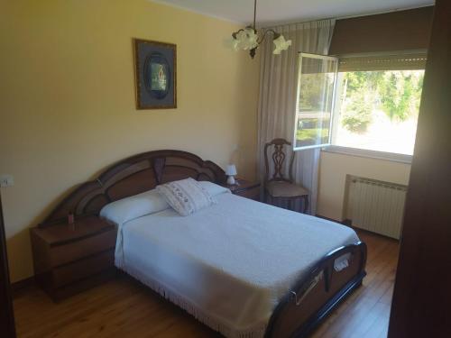 a bedroom with a large bed and a window at Casa Sopeña in Llanes