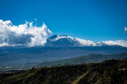 a snow covered mountain on top of a hill at Hotel Elios Tao in Taormina