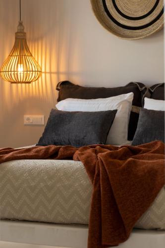 a bedroom with a bed with a blanket on it at Emery Hotel in Naxos Chora