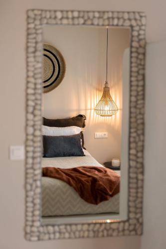 a mirror reflection of a bed in a bedroom at Emery Hotel in Naxos Chora