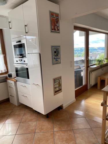 a white refrigerator in a kitchen with a window at Fewo Weinland in Zweibrücken
