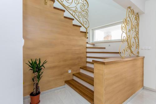 a staircase in a home with a wooden stair case at Villa QUERCUS in Krk
