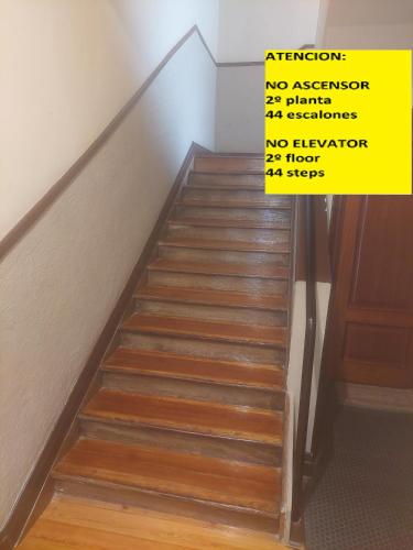 a set of stairs with a yellow sign on them at bilbao center apt 90´s PARKING in Bilbao
