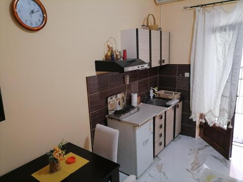 a small kitchen with a sink and a stove at Romana 1 in Tivat
