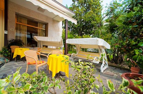 a patio with tables and chairs and a yellow table cloth at B&B Risorta in Abano Terme