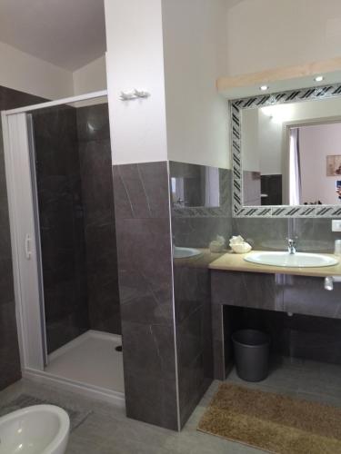 a bathroom with a shower and a sink at agriturismo heaven in Capo Vaticano