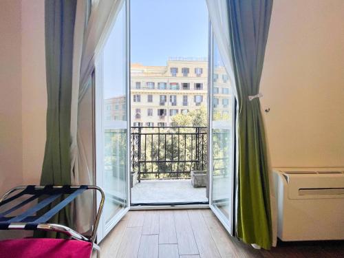 an open door to a balcony with a view of a building at B&B Mazzini in Rome