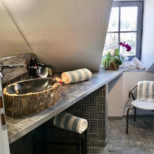 un comptoir de cuisine avec un évier et une fenêtre dans l'établissement In Sarlat Luxury Rentals, Medieval Center - Loft Stella Matutina -2p-ascenseur-climatisation, à Sarlat-la-Canéda