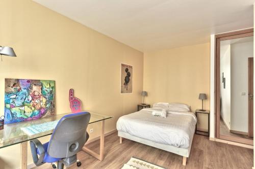 une chambre avec un lit et un bureau avec un ordinateur dans l'établissement Appartement Dombasle Tour Eiffel - Welkeys, à Paris