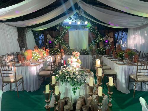 a wedding reception with white tables and chairs at Casa Cecilia Hotel in Bantay