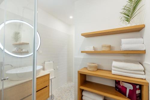 a bathroom with a sink and a glass shower at Magnolia Apartments 2 Herceg Novi in Herceg-Novi