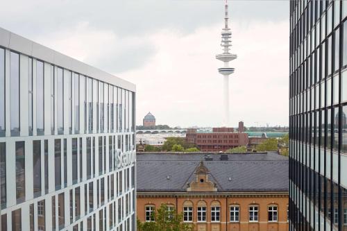 a tall building with a clock on the top of it at Scandic Hamburg Emporio in Hamburg