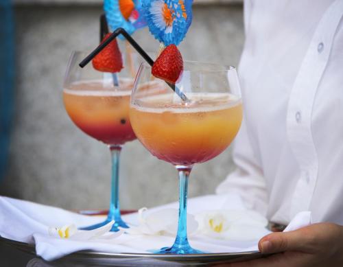 two glasses with fruit in them on a table at Hotel SJ in Tondela