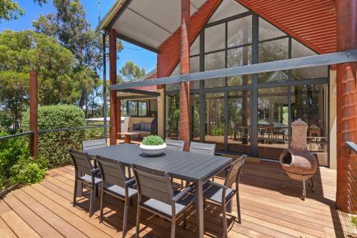 a patio with a table and chairs on a deck at Twilight Ridge - Situated on 2 acres of pristine bushland, Twilight Ridge offers both privacy and space in Quindalup