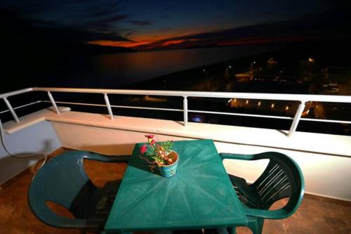 a green table and chairs on a boat at Top Relax in Vlorë