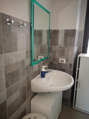 a bathroom with a sink and a mirror at Marilor Apartments in Catania