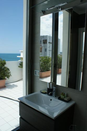 a bathroom with a sink and a mirror at La mia terrazza sul mare - Mared'aMare in Bari
