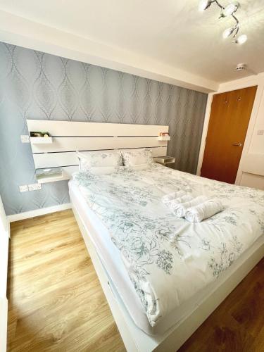 a bedroom with a bed with two pillows on it at Two bedrooms flat - Manchester city centre in Manchester