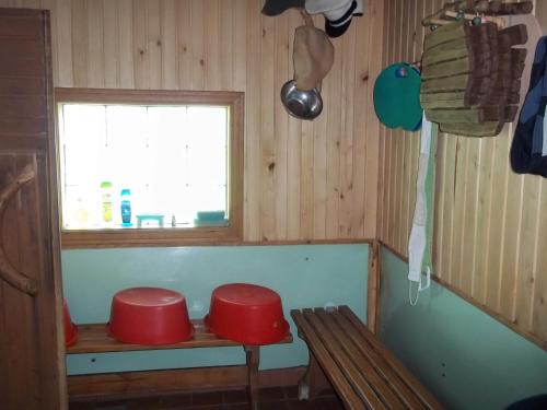 a room with two red stools and a window at Brīvdienu māja Skerškāni in Krāslava