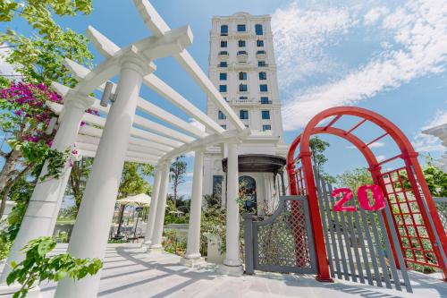 a gate with a sign in front of a building at Rex Quang Binh Hotel in Dong Hoi