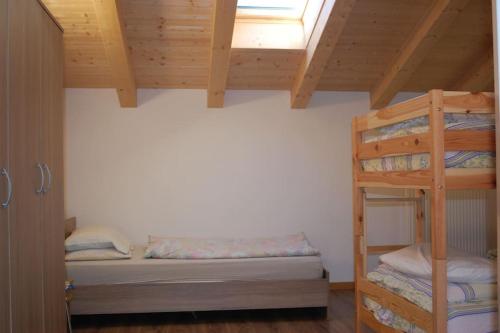 a bedroom with two bunk beds and a window at LA CIESA DEI SIORI in Alleghe