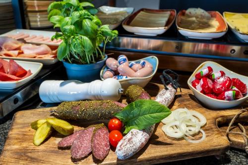 a bunch of different vegetables on a cutting board at mightyTwice Hotel Dresden in Dresden