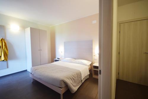 a bedroom with a bed with a white bedspread at Hotel La Siesta in Torino di Sangro