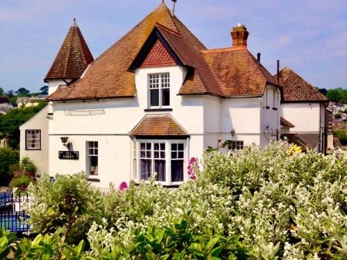 a white house with a brown roof at Lyme Regis renovated period seaside flat in Lyme Regis