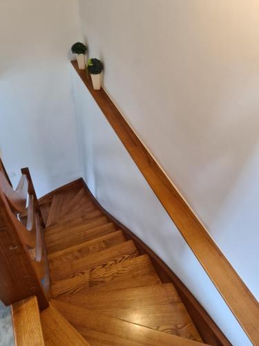 a stairway with wooden floors and a white wall at Domek pod Złotym Groniem in Istebna