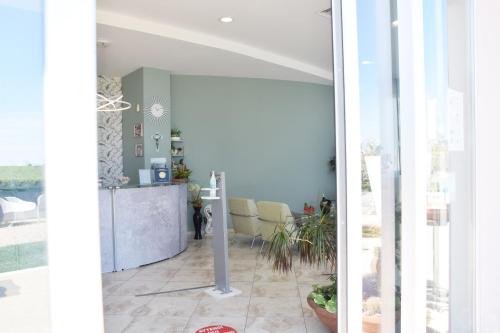 a living room with a door open to a dining room at Hotel La Siesta in Torino di Sangro