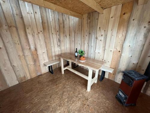 a wooden room with a table with a plant on it at Bouda Orlí Hnízdo in Němčovice