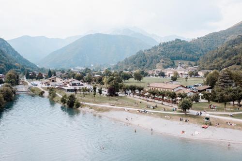 a view of a beach with mountains in the background at Hotel Da Franco e Adriana in Pieve Di Ledro