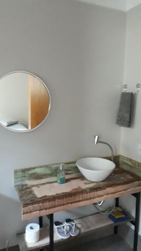 a bathroom with a sink and a mirror on a counter at STUDIO CENTRAL IV in Cascavel