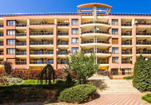 a large pink building with stairs in front of it at Nessebar, Apartment,South Beach, Larisa, in Nesebar