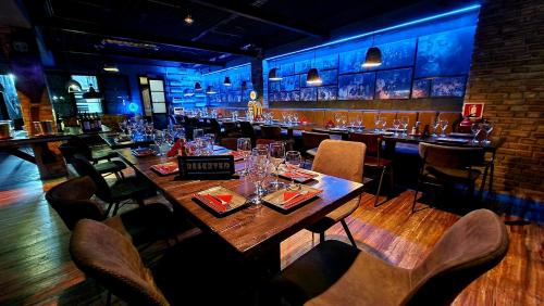 une longue table en bois dans un bar avec des chaises dans l'établissement Ocean Suites, à Santa Maria