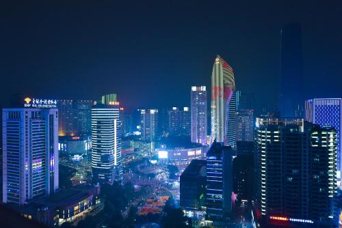 a night view of a city with tall buildings at King'sLandind BnB in Chongqing