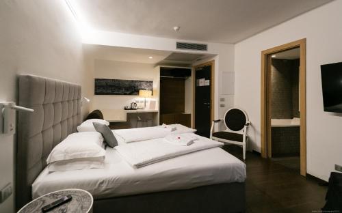 a hotel room with a bed and a desk at Boutique Exclusive B&B in Trento